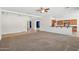 Spacious living room featuring carpet floors, tray ceilings, and open floor plan at 5557 W Mine Trl, Phoenix, AZ 85083