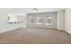 Bright living room with neutral walls, plush carpeting, and a bar area with a sink at 5557 W Mine Trl, Phoenix, AZ 85083