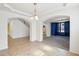 Open concept living area featuring neutral color scheme, arched doorways, and tile floors at 5557 W Mine Trl, Phoenix, AZ 85083