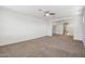 Spacious living area with carpet floors, ceiling fan, and easy access to other rooms at 5557 W Mine Trl, Phoenix, AZ 85083