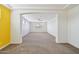 Large living area featuring carpet floors, arched doorways, and neutral color scheme at 5557 W Mine Trl, Phoenix, AZ 85083