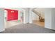 Open concept living area featuring carpet floors, arched doorways, and staircase at 5557 W Mine Trl, Phoenix, AZ 85083