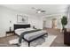 Spacious main bedroom with ceiling fan, soft rug, and neutral decor at 5557 W Mine Trl, Phoenix, AZ 85083