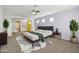 Large main bedroom featuring a ceiling fan, soft rug, and access to additional rooms at 5557 W Mine Trl, Phoenix, AZ 85083