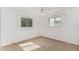 Bright bedroom with two windows, neutral carpet, and white trim at 6722 E El Paso St, Mesa, AZ 85205