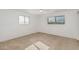 Simple bedroom with neutral carpeting and large windows providing natural light at 6722 E El Paso St, Mesa, AZ 85205