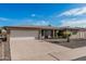 Lovely brick home featuring a two-car garage, desert landscaping, and a long driveway at 6722 E El Paso St, Mesa, AZ 85205