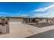 Well-maintained home with a spacious driveway, desert landscaping, and attached garage at 6722 E El Paso St, Mesa, AZ 85205