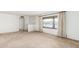 Bright living room with neutral carpet and a large window offering neighborhood views at 6722 E El Paso St, Mesa, AZ 85205