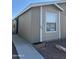 Exterior of home featuring tan siding, white trim, and well-maintained landscaping at 6839 W Taylor St # 209, Phoenix, AZ 85043