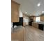 Kitchen featuring wood cabinets, modern appliances, and neutral countertops at 6839 W Taylor St # 209, Phoenix, AZ 85043