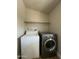 Laundry room features modern washer and dryer with overhead shelving at 6839 W Taylor St # 209, Phoenix, AZ 85043