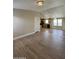 Open-concept living room and kitchen with wood-look flooring and natural light at 6839 W Taylor St # 209, Phoenix, AZ 85043
