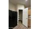 Kitchen with a view of a spacious, well-shelved pantry for storage at 6839 W Taylor St # 209, Phoenix, AZ 85043