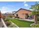 Large backyard area features lush greenery, a covered patio with outdoor seating and barbecue at 7070 W Andrea Dr, Peoria, AZ 85383