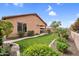 Well-manicured backyard with lush landscaping, green lawn, and a paved patio area at 7070 W Andrea Dr, Peoria, AZ 85383