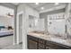 Bathroom features double sinks, granite countertops, a large mirror, and a glass-enclosed shower at 7070 W Andrea Dr, Peoria, AZ 85383