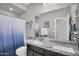 Bright bathroom with double sinks, granite countertops, and a shower-tub combination at 7070 W Andrea Dr, Peoria, AZ 85383