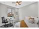 Comfortable bedroom with a desk, bright natural light, and modern minimalist decor at 7070 W Andrea Dr, Peoria, AZ 85383