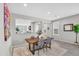 Modern dining area with wooden table, gray chairs, and plenty of natural light from large windows at 7070 W Andrea Dr, Peoria, AZ 85383