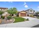 Charming front exterior showcases a well-manicured lawn, desert landscaping, and a two-car garage at 7070 W Andrea Dr, Peoria, AZ 85383