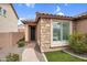 Charming front exterior with stone accents, tile roof, well-maintained lawn, and walkway at 7070 W Andrea Dr, Peoria, AZ 85383