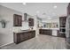 Modern kitchen featuring stainless steel appliances, dark cabinetry, granite countertops, and tile backsplash at 7070 W Andrea Dr, Peoria, AZ 85383