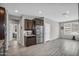 Modern kitchen area with stainless steel appliances, wood cabinetry, and eat-in dining space at 7070 W Andrea Dr, Peoria, AZ 85383