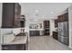 Spacious kitchen featuring stainless steel appliances, granite counters, and dark wood cabinets at 7070 W Andrea Dr, Peoria, AZ 85383