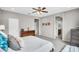 Comfortable bedroom featuring a ceiling fan, neutral walls, and a view into the ensuite bathroom at 7070 W Andrea Dr, Peoria, AZ 85383