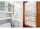 Cozy bathroom with white vanity, wooden door, and natural light at 7252 E Edgewood Ave, Mesa, AZ 85208