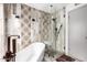 Modern bathroom showcasing a walk-in shower, a soaking tub and designer tile accents at 7252 E Edgewood Ave, Mesa, AZ 85208