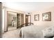 Bedroom featuring a mirrored closet and a bed with neutral bedding at 7252 E Edgewood Ave, Mesa, AZ 85208