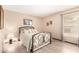 Cozy bedroom with a metal frame bed, bright natural light and wood-look floors at 7252 E Edgewood Ave, Mesa, AZ 85208