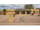 Charming single-story home with a tiled roof, desert landscaping, and a secure gated entry for added privacy at 7252 E Edgewood Ave, Mesa, AZ 85208