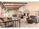 Spacious living room with vaulted ceilings, wooden beams, and a view into the adjacent dining area at 7252 E Edgewood Ave, Mesa, AZ 85208