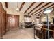 Open living area featuring vaulted ceilings, wooden beams, and a seamless transition to the dining space at 7252 E Edgewood Ave, Mesa, AZ 85208