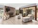 Comfortable living space with a brick fireplace and views of an indoor garden, creating a relaxing atmosphere at 7252 E Edgewood Ave, Mesa, AZ 85208