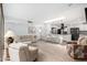 Bright living room featuring modern furnishings and an open-concept kitchen with stainless steel appliances at 7252 E Edgewood Ave, Mesa, AZ 85208