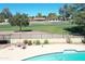 Aerial view of pool with patio furniture with golf course and neighborhood in background at 7252 E Edgewood Ave, Mesa, AZ 85208