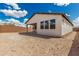 View of the home exterior featuring a covered patio and unlandscaped backyard space at 7342 W Hedge Hog Pl, Peoria, AZ 85383