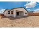 Unlandscaped backyard features a covered patio, block fence, and the promise of customization at 7342 W Hedge Hog Pl, Peoria, AZ 85383
