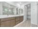 Modern bathroom featuring double vanity, marble counters, and walk-in shower and walk-in closet access at 7342 W Hedge Hog Pl, Peoria, AZ 85383
