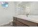 Well-lit bathroom features a brown cabinet with white countertop, undermount sink, and a window with a view at 7342 W Hedge Hog Pl, Peoria, AZ 85383