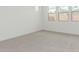 Bedroom with light carpet, white walls, and three windows bringing in ample natural light at 7342 W Hedge Hog Pl, Peoria, AZ 85383