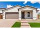 Inviting front exterior of a single-story home with a well-maintained lawn and tiled roof at 7342 W Hedge Hog Pl, Peoria, AZ 85383