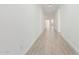 Long hallway features neutral-toned tile flooring and ample natural light at 7342 W Hedge Hog Pl, Peoria, AZ 85383