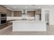 Beautiful kitchen with stainless steel appliances, stylish backsplash, and a large center island at 7342 W Hedge Hog Pl, Peoria, AZ 85383