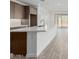 Bright, open kitchen featuring a large island with quartz countertops and wood-look floors at 7342 W Hedge Hog Pl, Peoria, AZ 85383