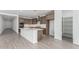 Bright, modern kitchen with stainless steel appliances and a large island with quartz countertops at 7342 W Hedge Hog Pl, Peoria, AZ 85383